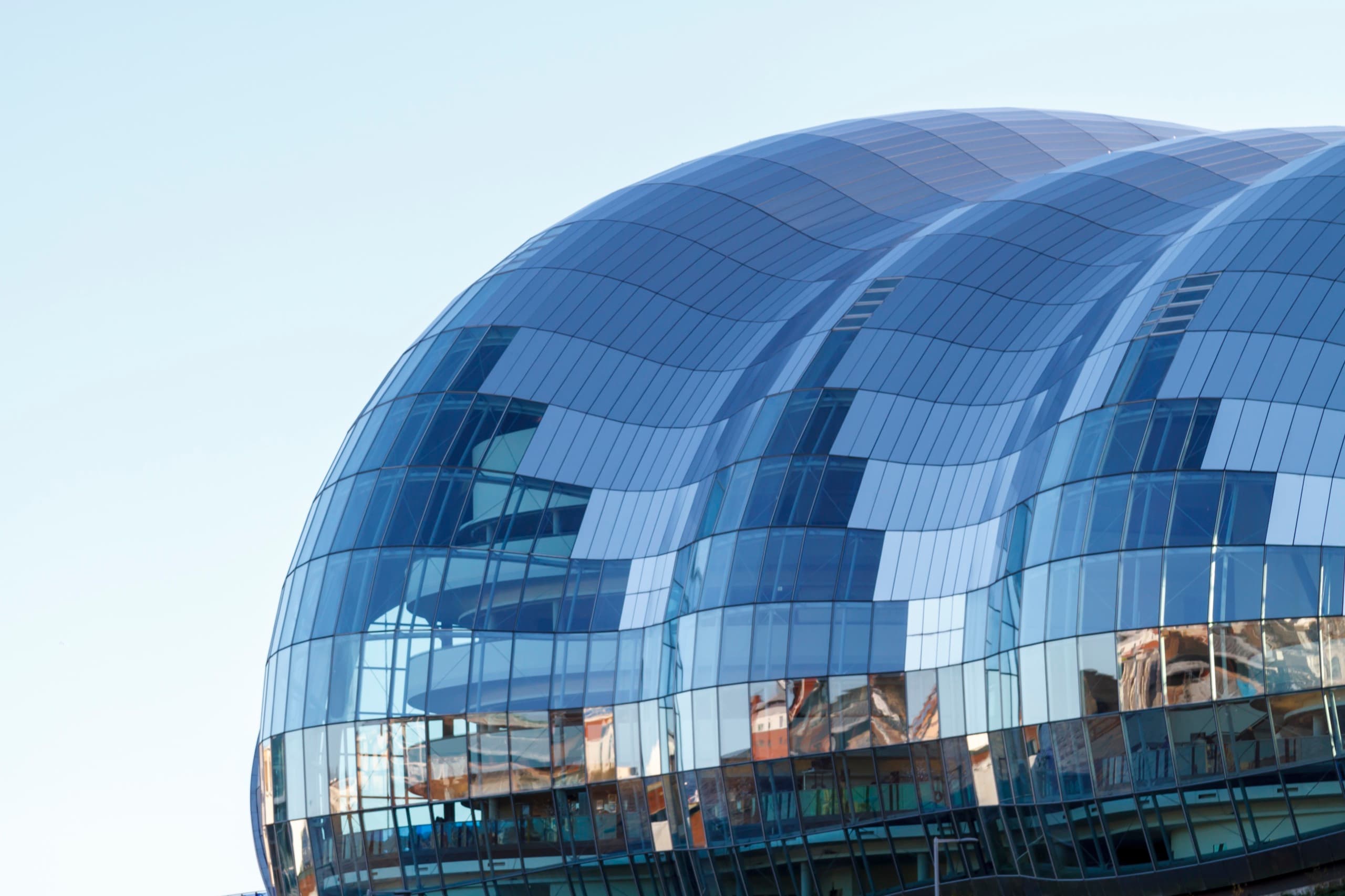 Exterior of a curved blue-glass building